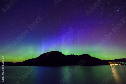 colorful northern lights (Aurora Borealis) at fjord landscape, Norway, Europe 