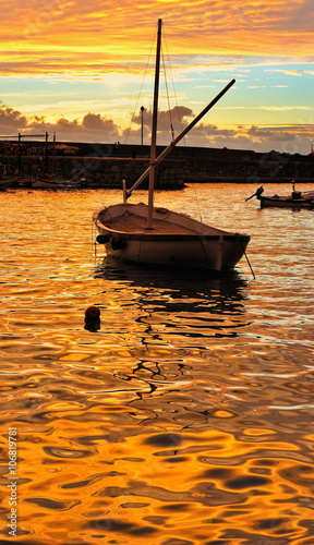 fishing boat at gold sunset