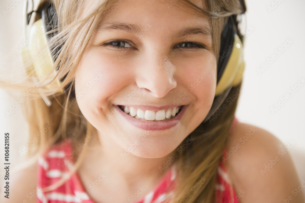 Close up of Caucasian girl wearing headphones Close up of Caucasian girl wearing headphones