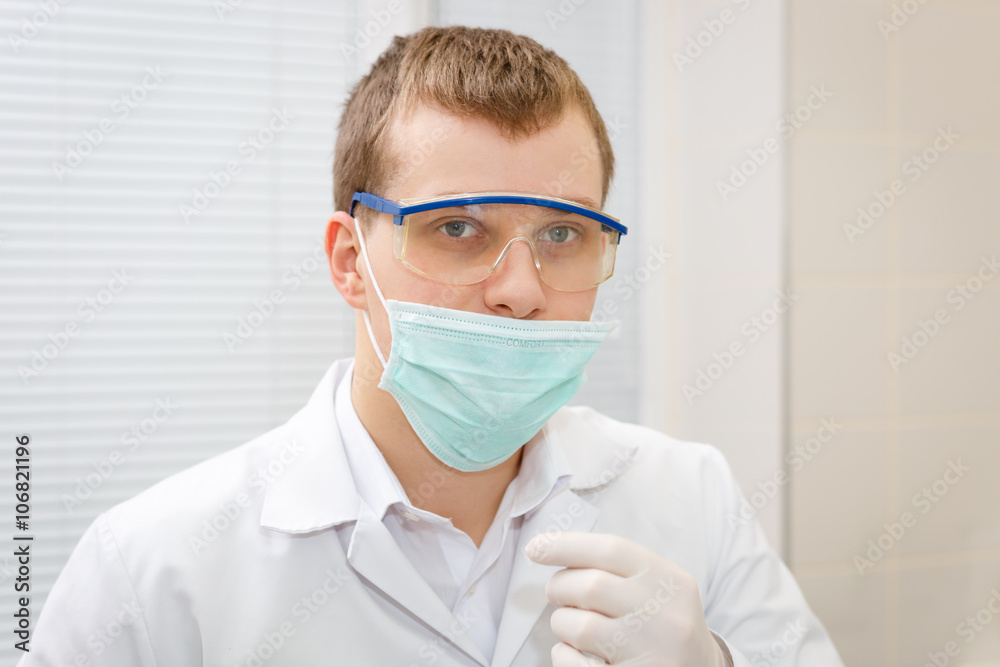 Portrait of a young man dentist in dental clinic Portrait of a young man dentist in dental clinic