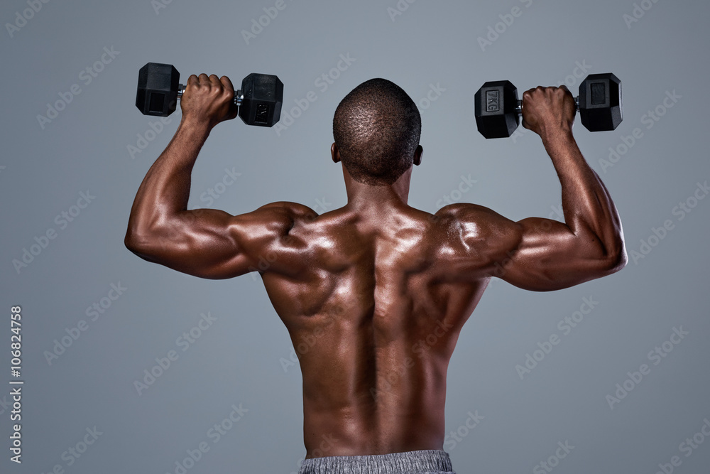 black man with strong muscular back muscles lifting weights