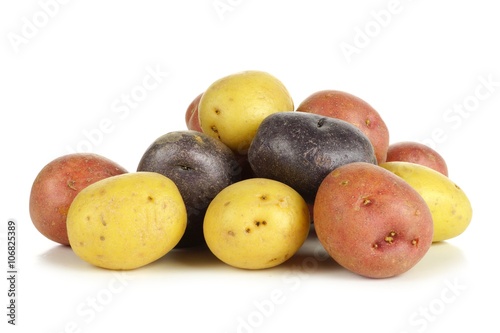 Pile of colorful fresh little potatoes over a white background