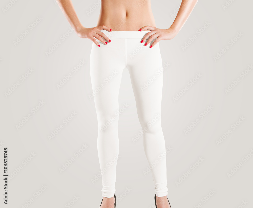 Woman wear blank white leggings mockup, isolated on grey. Women in clear  leggins template. Cloth pants design presentation. Sport pantaloons stretch  tights model wearing. Slim legs figure in cotton. Stock Photo