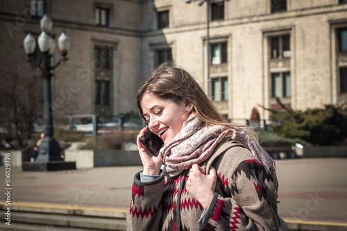 Young woman talking on mobile phone © yuliiakas