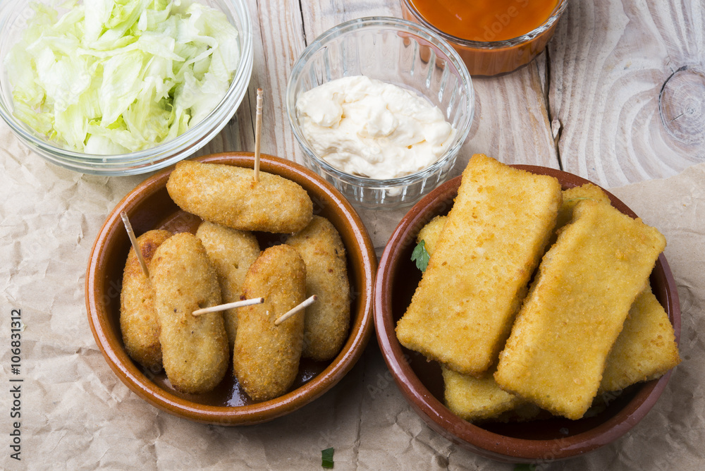 croquettes balls and different kind of sauces on a plate on a cl croquettes balls and different kind of sauces on a plate on a cl