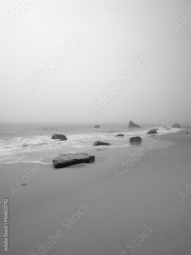 image of a tranquil beach with rocks.