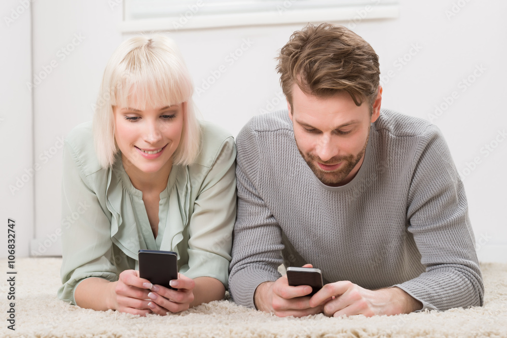 Happy Couple Holding Cellphones Happy Couple Holding Cellphones