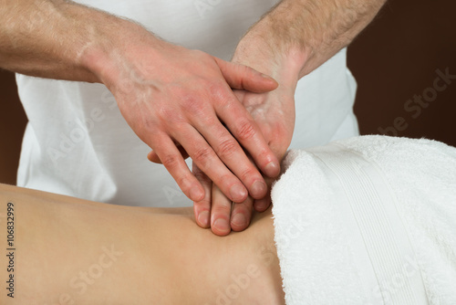 Woman Receiving Back Massage In Spa