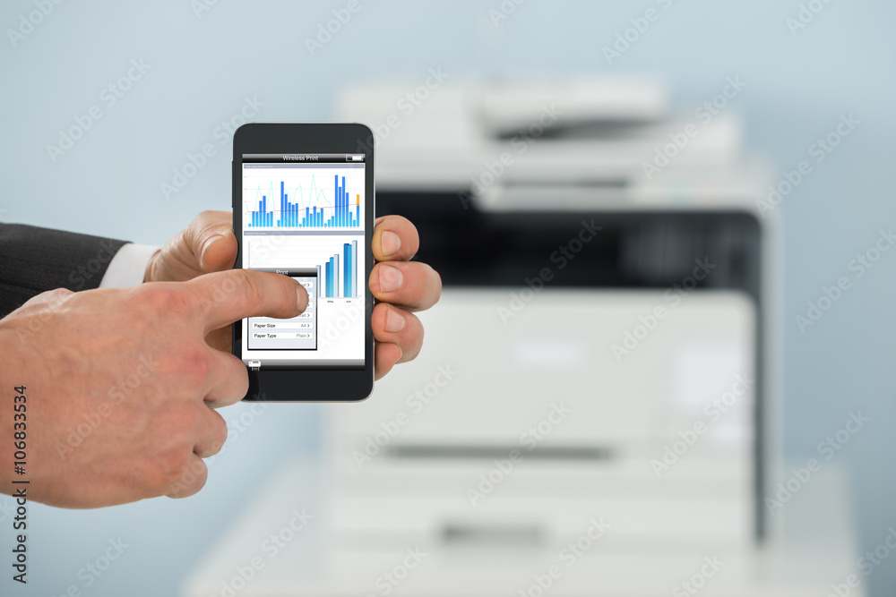 Businessman Using Cellphone For Printing Graph Paper Businessman Using Cellphone For Printing Graph Paper