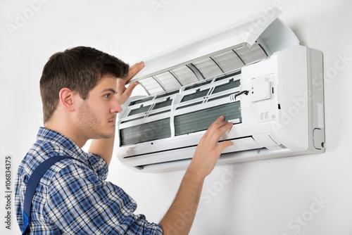 Technician Repairing Air Conditioner