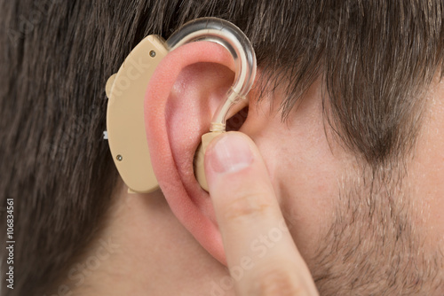 Man Wearing Hearing Aid In Ear