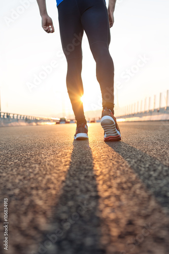 feet of an athlete running on a park pathway training for fitnes