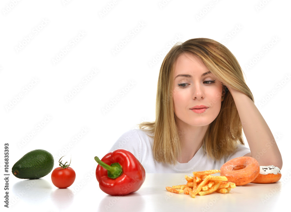 Dietician woman looking at vegetables avocado tomato pepper and Dietician woman looking at vegetables avocado tomato pepper and
