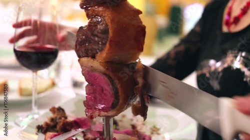 Closeup of a Picanha beef cutting.  Set table blurred steakhouse restaurant background    