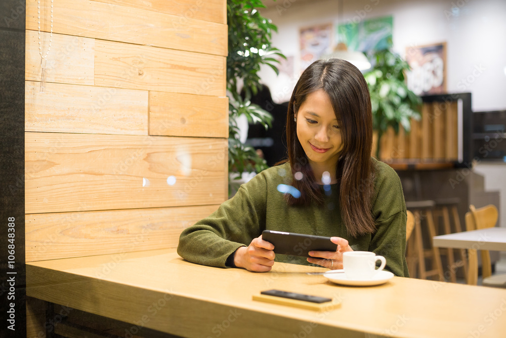 Woman use of smart phone in cafe at night Woman use of smart phone in cafe at night