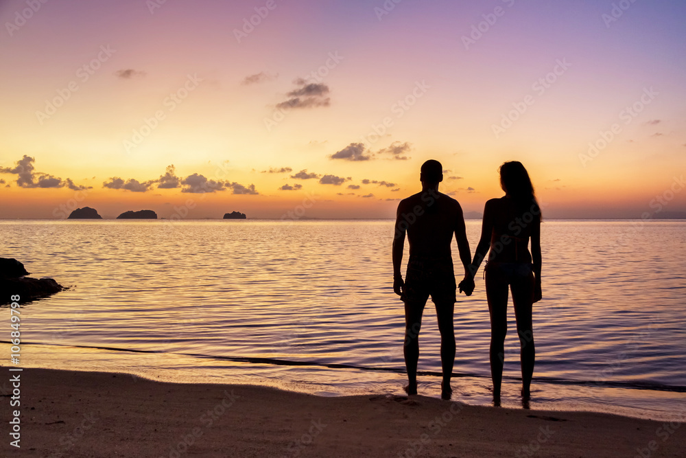 Young couple stay on the beach at sunset on Koh Samui, Thailand