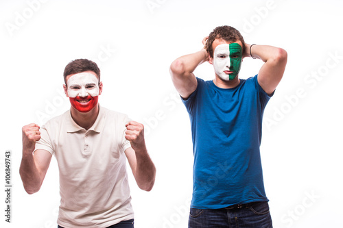 Northern Ireland vs Poland. Football fans of national teams demonstrate emotions: Northern Ireland lose, Poland win. European 2016 football fans concept. photo