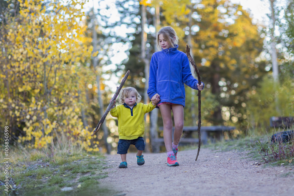Caucasian children hiking on dirt path in forest Caucasian children hiking on dirt path in forest