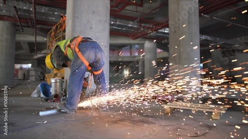 Electric wheel grinding on steel structure in construction site