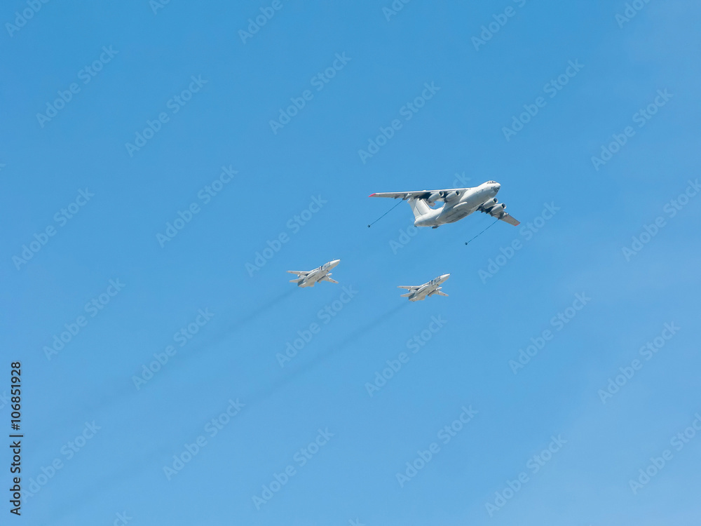 Ilyushin Il-78 (Midas) four-engined aerial tanker demonstrates refueling of 2 Sukhoi Su-24 (Fencer) supersonic all-weather attack aircrafts on blue sky background
Ilyushin Il-78 (Midas) four-engined aerial tanker demonstrates refueling of 2 Sukhoi Su-24 (Fencer) supersonic all-weather attack aircrafts on blue sky background