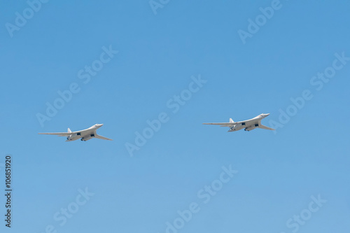2 Tupolev Tu-160 (Blackjack) supersonic variable-sweep wing heavy strategic bomber fly on blue sky background 