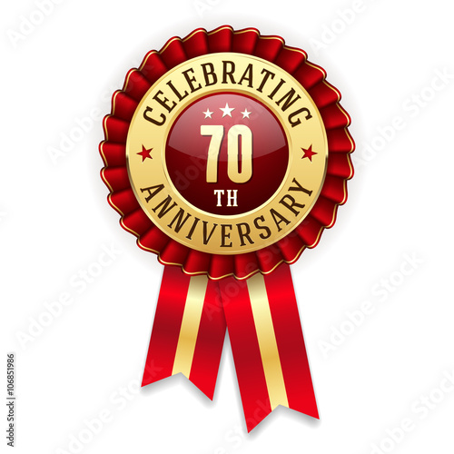 Gold 70th anniversary badge, rosette with red ribbon on white background