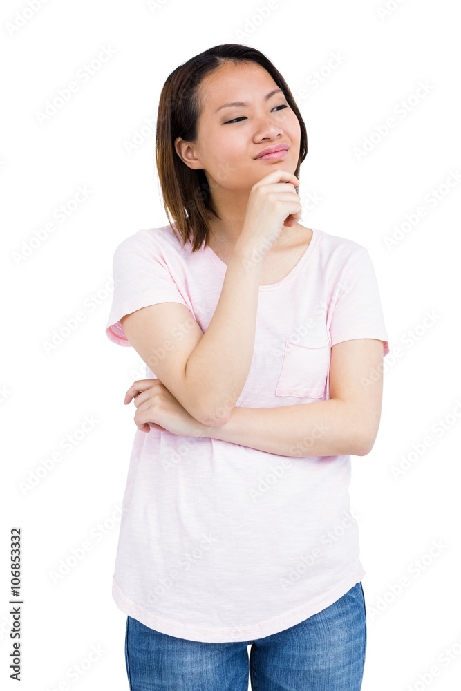 Thoughtful young woman standing with hand on chin Thoughtful young woman standing with hand on chin