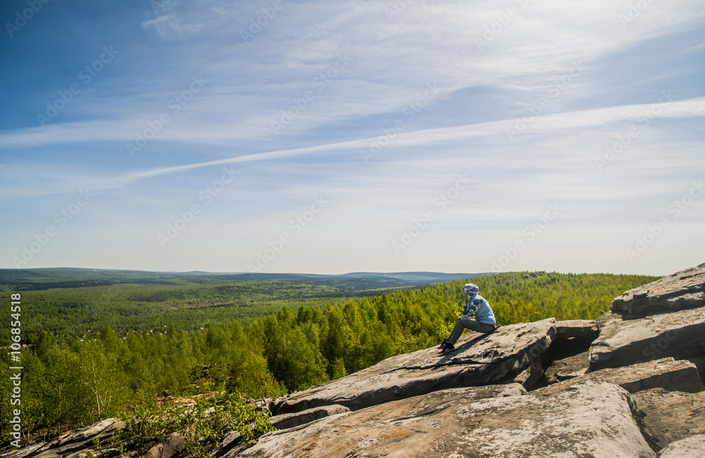 Caucasian climber sitting on rock formation Caucasian climber sitting on rock formation