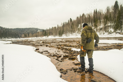 Caucasian hiker walking in rocky remote river