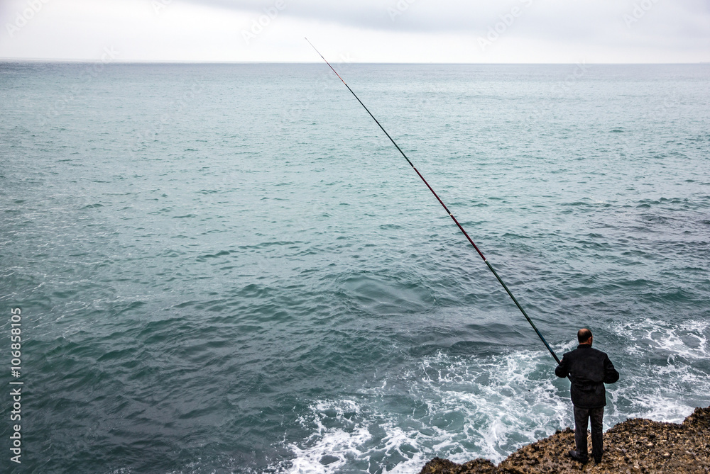 fisher with rod, Mediterranean seaside, Spain