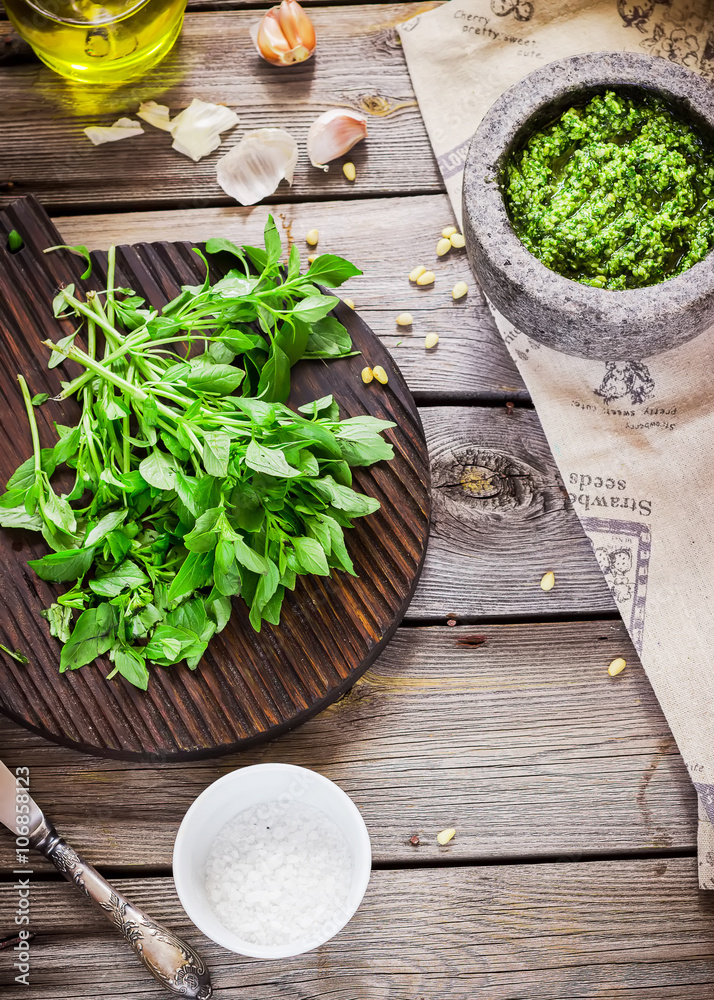 Pesto and ingredients on wooden table. Pesto and ingredients on wooden table.