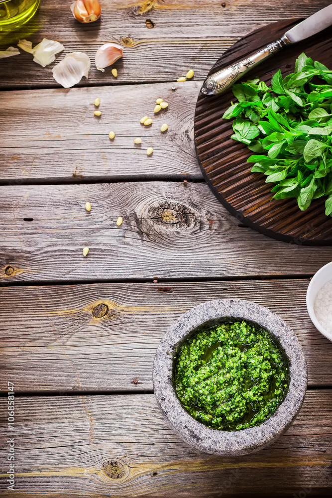 Pesto and ingredients on wooden table. Pesto and ingredients on wooden table.