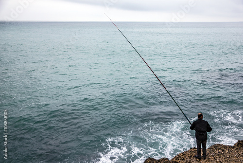 fisher with rod, Mediterranean seaside, Spain