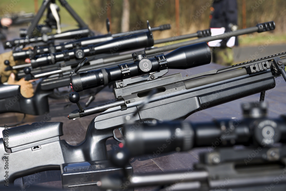 Military sniper aims at a target