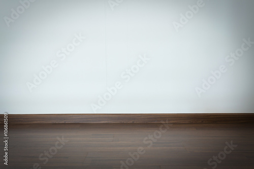 empty room, white mortar wall background and wood laminate floor