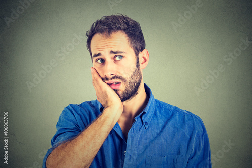 No motivation in life. Sad worried man isolated on gray wall background