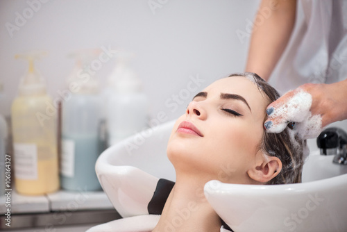 Pleasant woman sitting in the hairdressing salon 