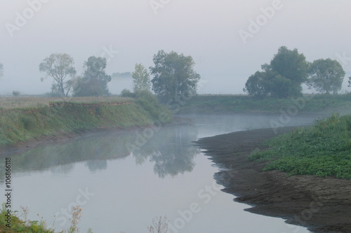 Misty sunset on the river photo