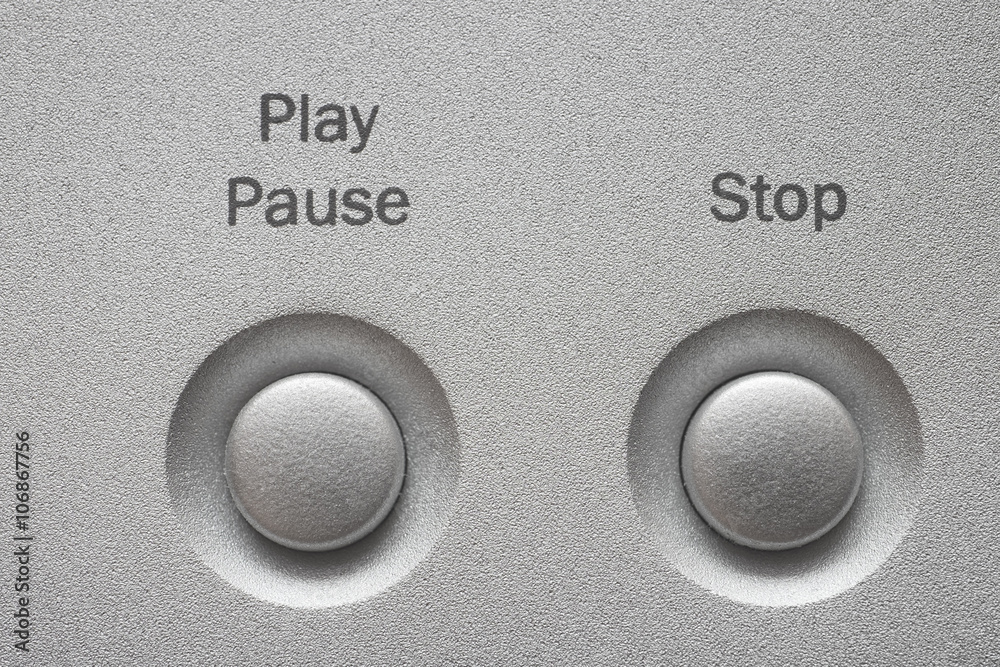 Macro of Play, Pause and Stop buttons on aluminum panel. Macro of Play, Pause and Stop buttons on aluminum panel.