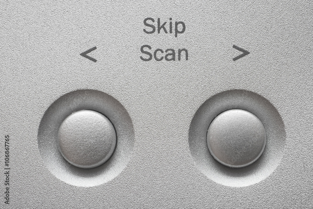Macro of Skip, Scan buttons on aluminum panel. Macro of Skip, Scan buttons on aluminum panel.