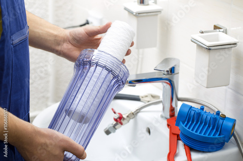 plumber installing new water filtration system