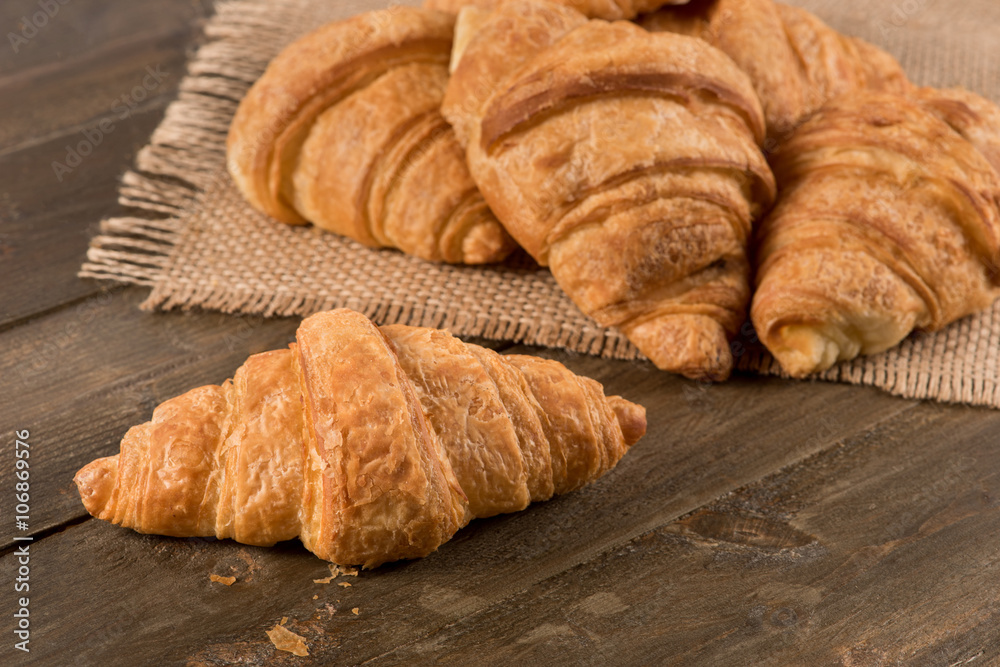 Breakfast croissant on a rustic background