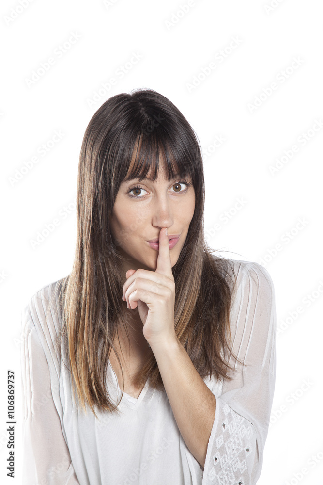 Portrait of beautiful young woman with silent gesture on white background Portrait of beautiful young woman with silent gesture on white background