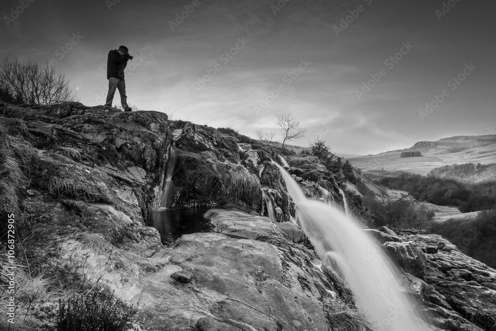 Photographer shooting into the Loup of Fintry Waterfall Photographer shooting into the Loup of Fintry Waterfall