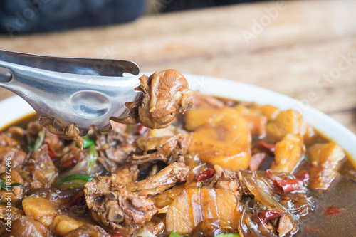 close up of baked chicken with vermicelli , potato , vegetable a