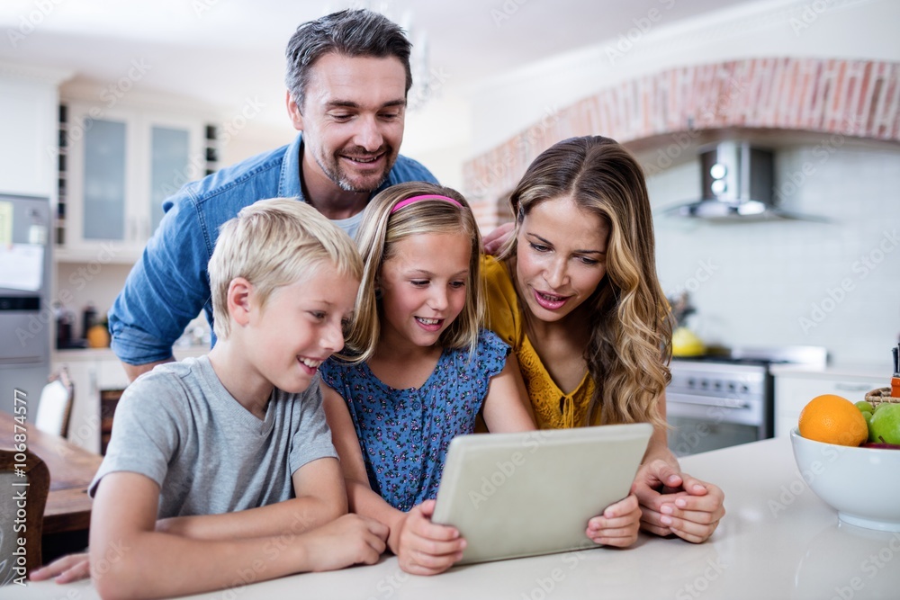 Parents and kids using digital tablet in kitchen Parents and kids using digital tablet in kitchen