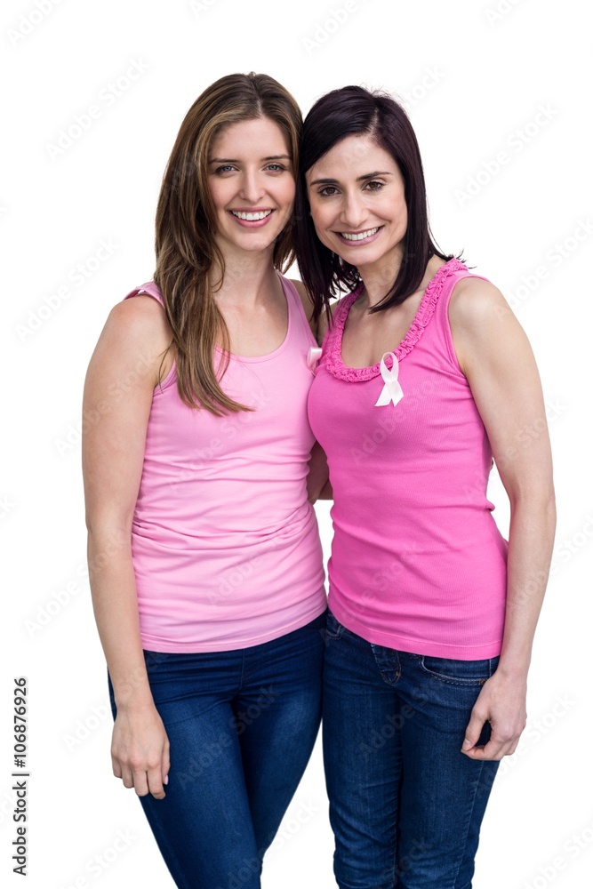 Smiling women in pink outfits posing for breast cancer awareness Smiling women in pink outfits posing for breast cancer awareness