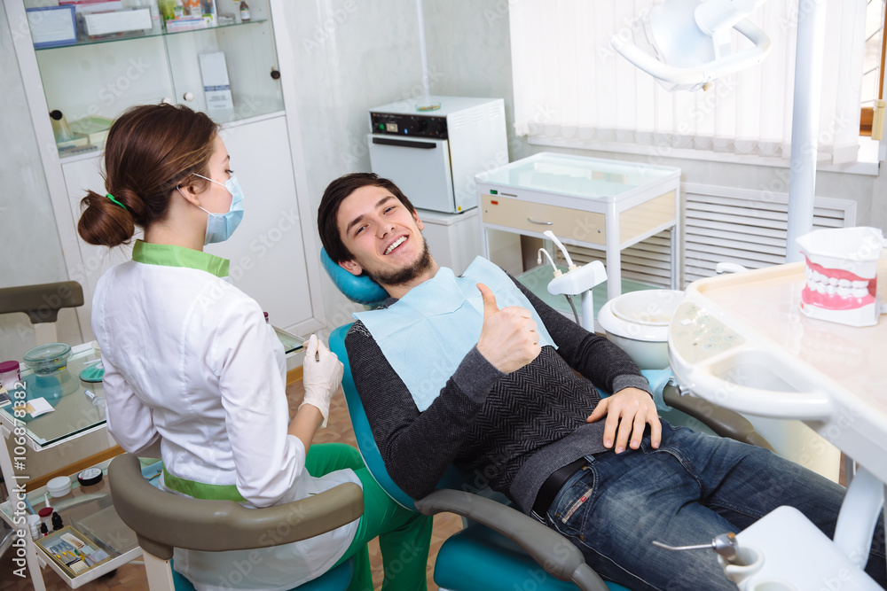 Patient of dental clinic smileing in the chair