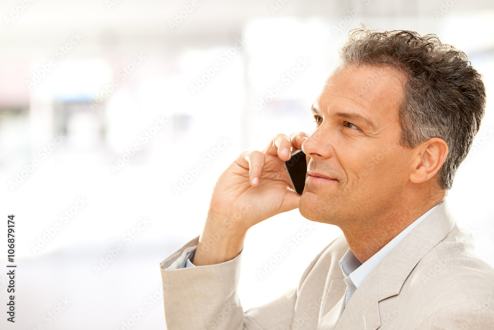 handsome smiling businessman talk on phone at office handsome smiling businessman talk on phone at office