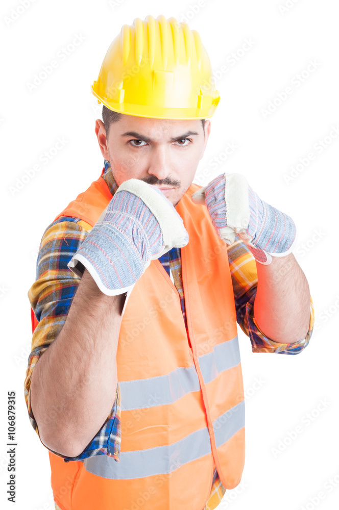 Furious engineer showing his fists and standing in fighting posi